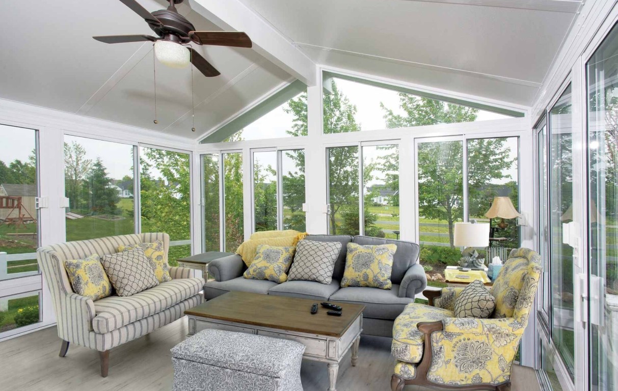 Interior of comfortable four-season sunroom with vaulted ceiling and large windows in Peoria, AZ